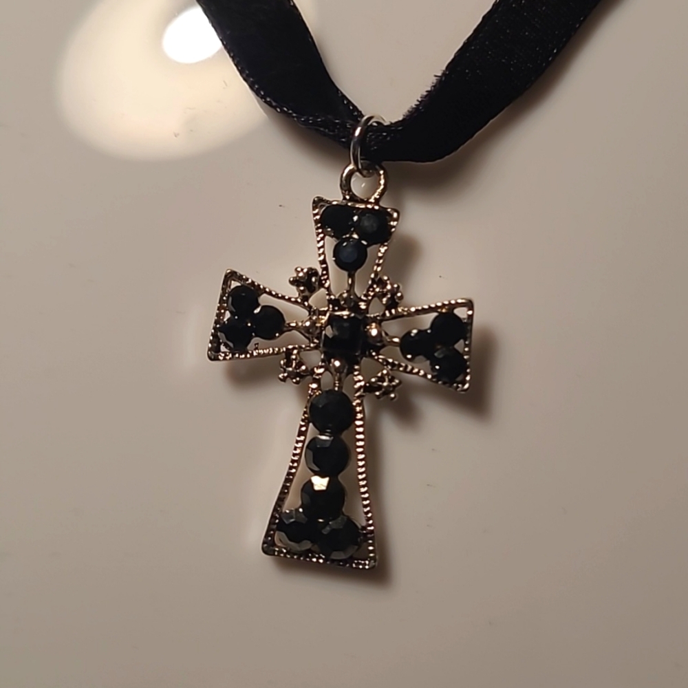 Silver cross with black rhinestones